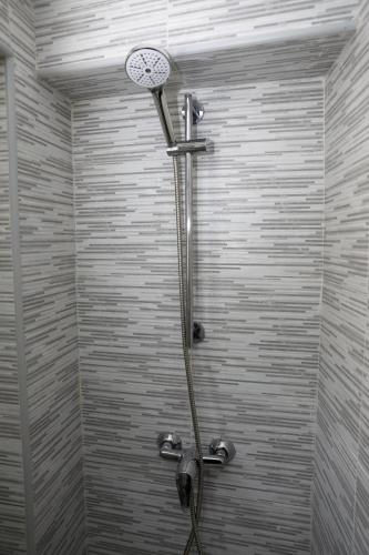 a shower with a shower head in a bathroom at La casita de Paco in Barbate