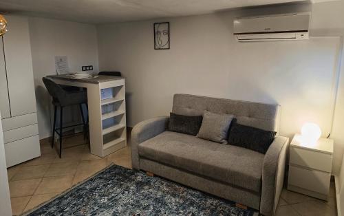a living room with a couch and a table at Piqueno Vendégház in Celldömölk