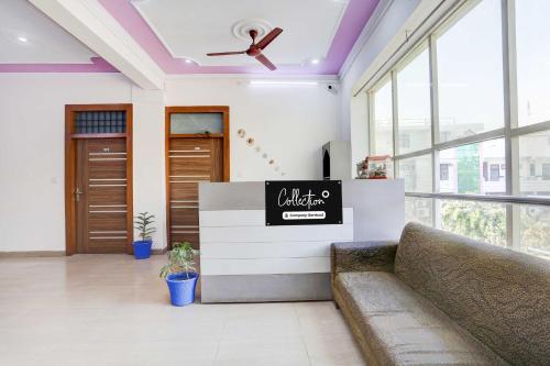 a lobby with a couch and a ceiling fan at Collection O Sector 4 Gurgaon in Gurgaon