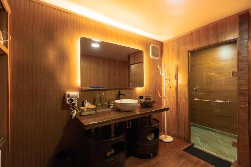 a bathroom with a sink and a mirror at Pondanu Living in Bedugul