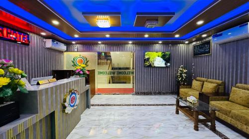 a lobby with a waiting area with couches and a tv at The Ambassador Hotel Dhanmondi in Dhaka