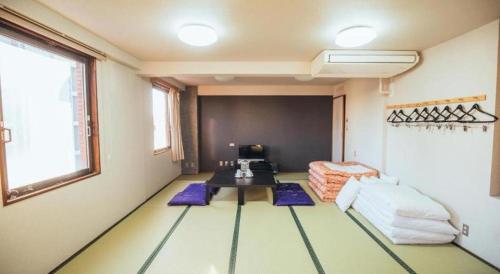 a living room with a table and a couch at Hotel Areaone Miyazaki in Miyazaki