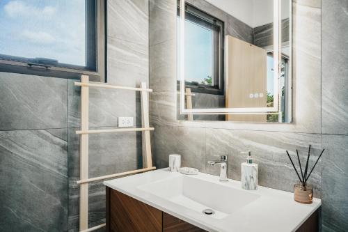 a bathroom with a sink and a mirror at RYANNA Samui in Choeng Mon Beach