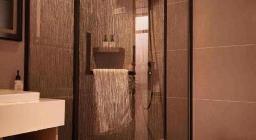 a bathroom with a shower with a glass door at GreenTree Inn Datong YundinGYAyuan Express Hotel in Datong