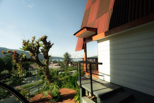 a balcony of a house with a view of a tree at Pondanu Living in Bedugul