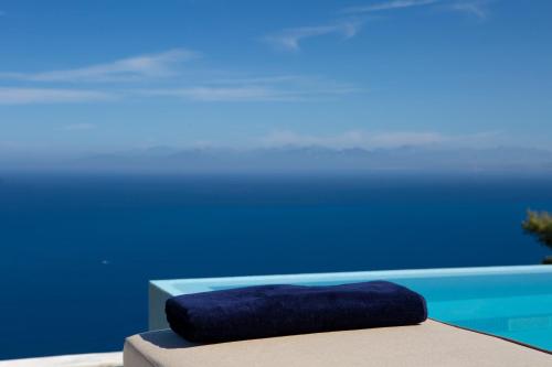 a blue pillow sitting on top of a table at Ionian Horizon Villas in Tsoukaladhes
