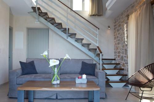 a living room with a couch and a table at Ionian Horizon Villas in Tsoukaladhes