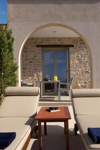 an outdoor patio with two couches and a table at Ionian Horizon Villas in Tsoukaladhes