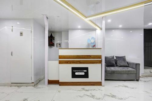 a living room with a couch and a table at Townhouse Oak Kachighati ISBT Shimla in Shimla