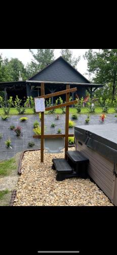 a bench and a gazebo in a garden at Siedlisko Wyżne in Wyżne