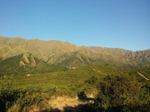 a view of a mountain range with mountains in the background at La Loma Resort in Merlo