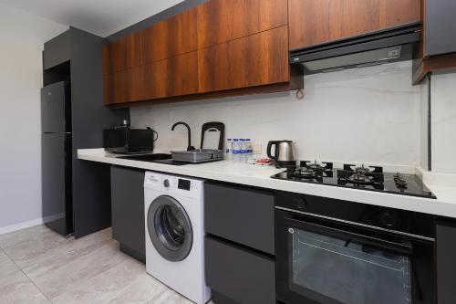 a kitchen with a stove and a washing machine at Sia Hotel Thermal & Spa in Nilüfer