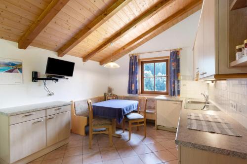 a kitchen with a table and a blue table at Ausser Brugghof in Senales