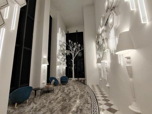 a hallway with blue chairs and a rug at 1-12PAXKuala Lumpur Near Taman MIDAH Cheras 2 Car Parking normally 1 parking only in Kuala Lumpur