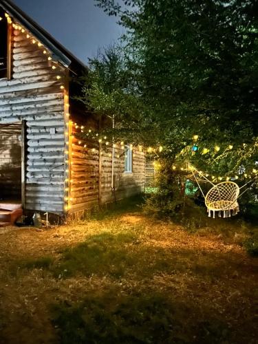 a house with christmas lights on the side of it at Деревяшка in Kara-Oy