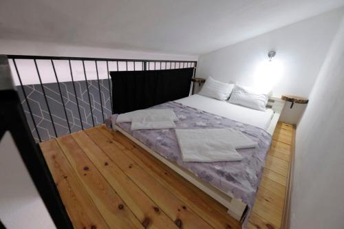 a bedroom with a bed and a wooden floor at Dado in Virpazar