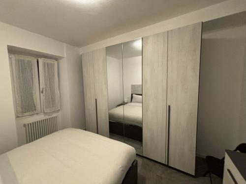a bedroom with a white bed and a closet at 22 di lucia in Lecco