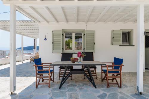 a dining table and chairs on a patio at Iremia Coastal Retreat in Neo Klima