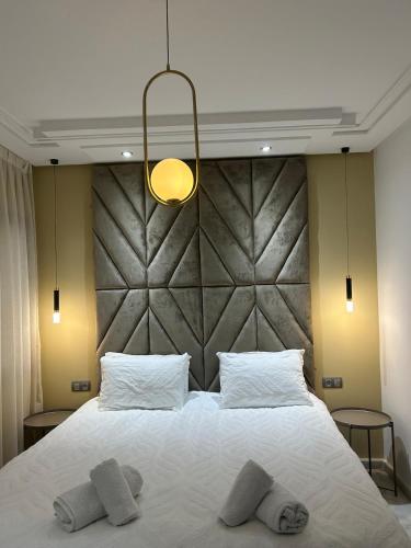 a bedroom with a large white bed with two pillows at Sofia 1 Tanger #Castilla in Tangier