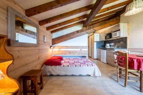 une chambre avec un lit dans une pièce aux murs en bois dans l'établissement Studio 7 - La Pierramenta, à Cohennoz