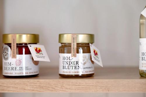 three jars of honey sitting on a shelf at Ausser Brugghof in Senales