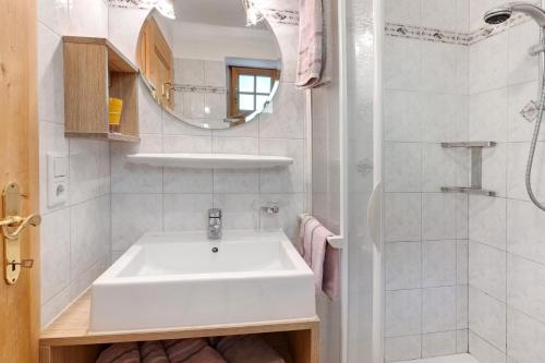 a white bathroom with a sink and a shower at Ausser Brugghof in Senales