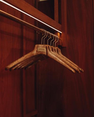 a wooden hanger on a wall in a bathroom at Entikko Safari Lodge in Fajao