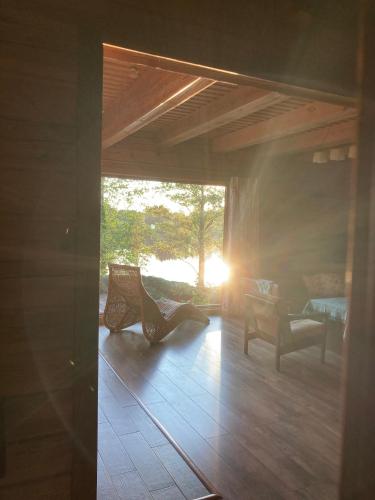 a room with chairs and the sun shining through a window at Litewska Chata 