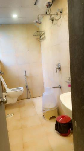 a bathroom with a toilet and a sink at Savali Resort in Diveagar