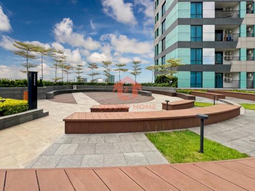 a park with benches in front of a building at Cozy Studio South Gate Apt with Pool, Gym, Wi-Fi by 2ndHome in Jakarta