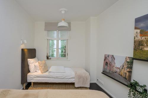a white room with a bed and a window at Tallinn Old Town silent garden House in Tallinn