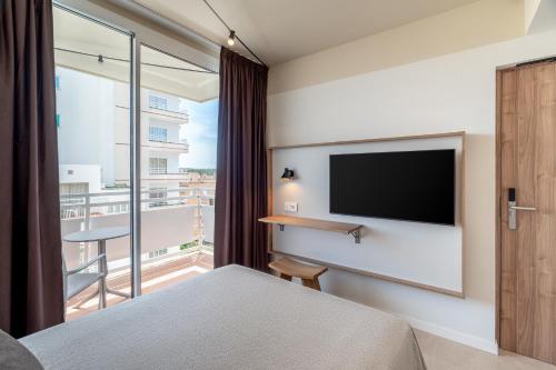 a bedroom with a flat screen tv on a wall at tent Arenal in El Arenal