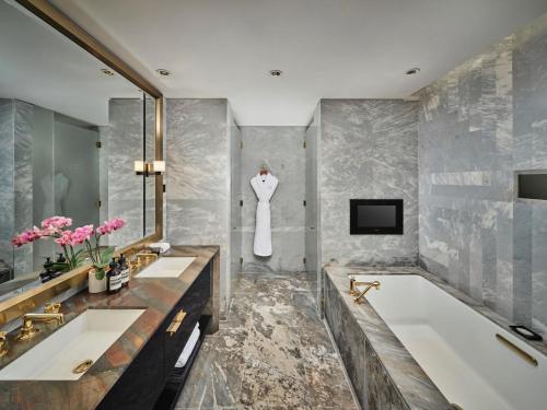 a bathroom with two sinks and a bath tub at Waldorf Astoria Beijing in Beijing