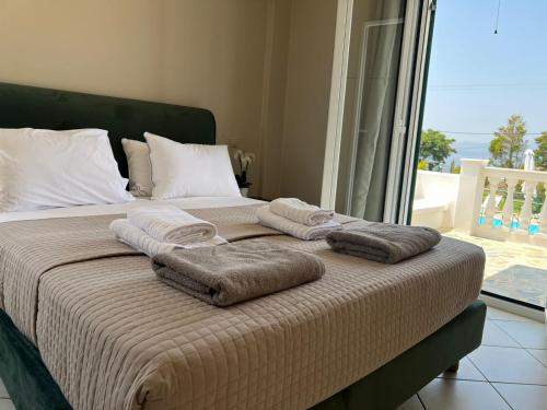 a bed with towels on it with a view of the ocean at Eglina Celeste Villa in Minia