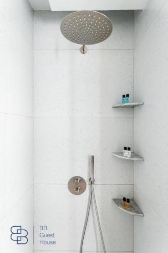 a bathroom with a shower with a light and shelves at Boulevard 129 in Tashkent