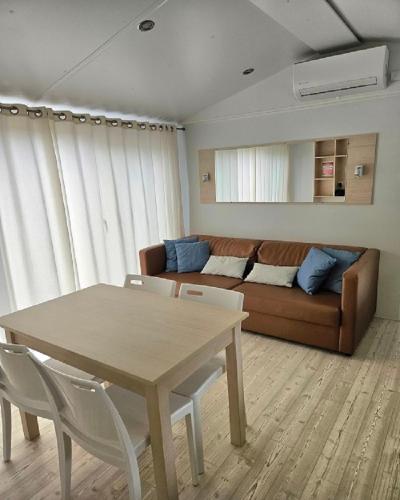a living room with a table and a couch at Camping de Charlieu in Charlieu
