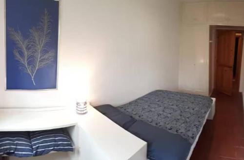 a small room with a bed and a desk at Guest House Nuraghe Majori in Tempio Pausania