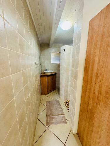a bathroom with a walk in shower and a sink at The Well, Mokopane in Mokopane