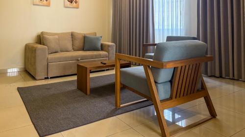 a living room with a chair and a couch at Majestic City Suites & Beach Hotel in Willemstad