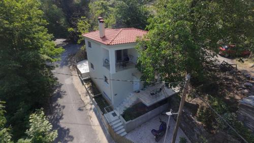 a white house with a chimney on top of it at Villa Eva I in Nédhousa