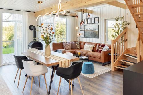 a dining room and living room with a table and chairs at Pet-Welcoming Stay with Sauna, Style & Privacy in Wandlitz