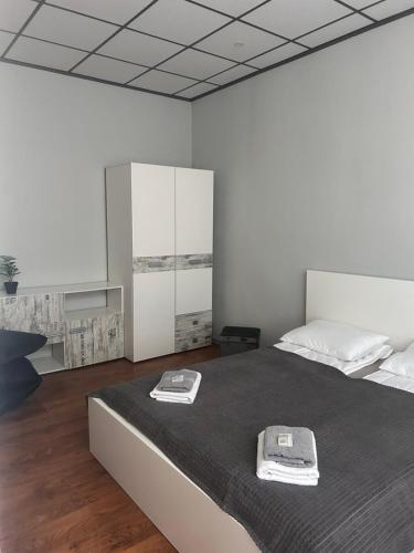 a bedroom with a bed with two towels on it at KunK in Ventspils