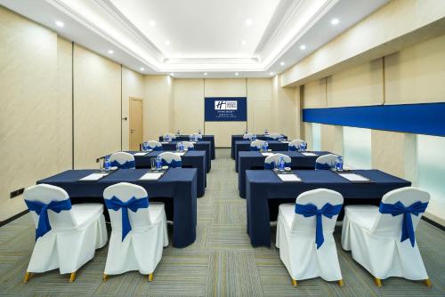 a conference room with blue tables and white chairs at Holiday Inn Express Chengdu Tianfu Square by IHG - Chunxi Road and Kuanzhai Alley in Chengdu
