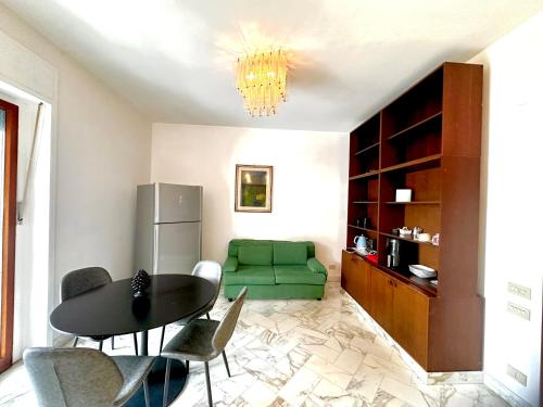 a living room with a table and a green couch at suite sorrento center in Sorrento