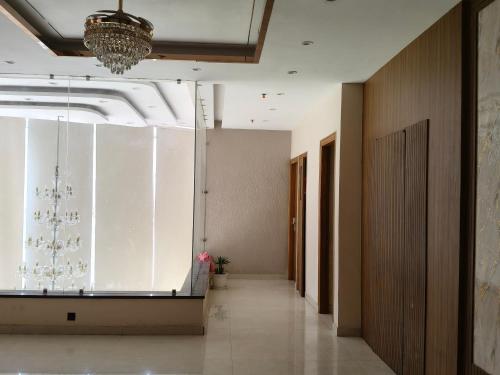 a hallway with a large glass window in a building at Hotel Chandraa Celebration ISBT Graphic in Dehradun