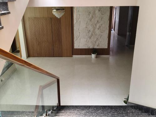 an empty hallway with a staircase in a building at Hotel Chandraa Celebration ISBT Graphic in Dehradun