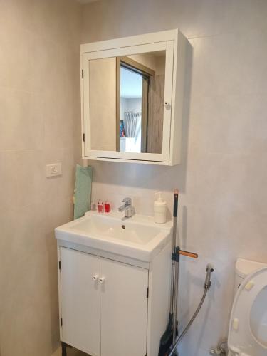 een badkamer met een witte wastafel en een spiegel bij В11 Title Naiyang Ватсап669З5В2I976 in Nai Yang Beach