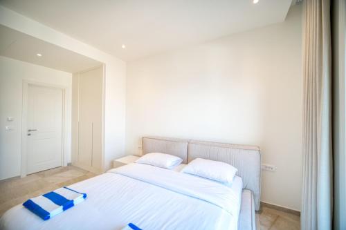 a bedroom with a bed with blue pillows on it at Lustica Bay Marina Village by 2BHome in Lustica