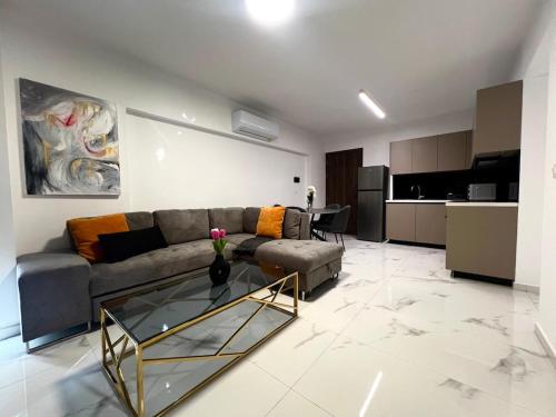 a living room with a couch and a glass table at Nicosia City Centre City Vibes Luxury 1BD in Nicosia