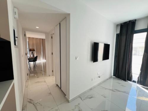 a hallway with white walls and a large mirror at Nicosia City Centre City Vibes Luxury 1BD in Nicosia